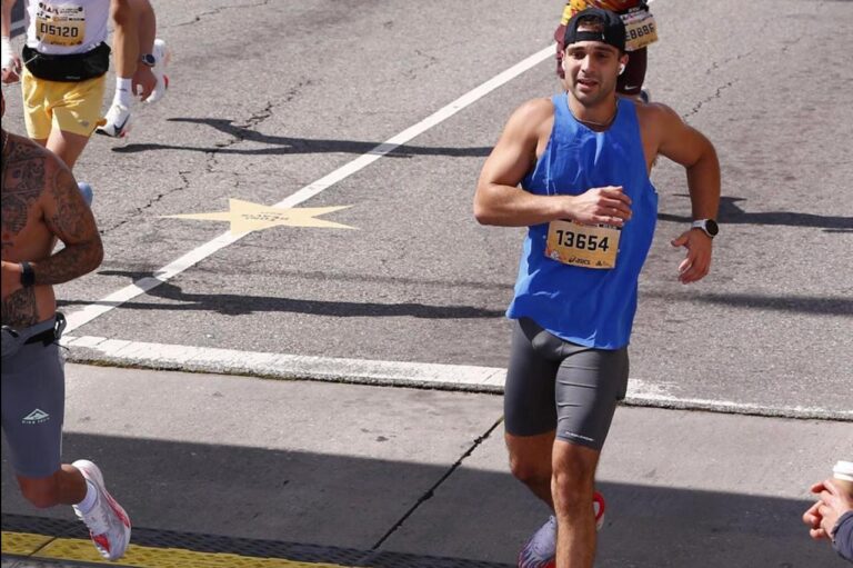 Marathon runner mid-race with a race bib